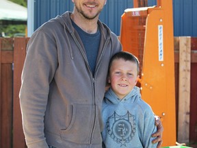 Art Vrolyk and his son Ben offer fresh rhubarb to buyers at the Sarnia Farmers' Market on Saturday. Rhubarb is the first produce of the new season for Vrolyk Farms.Photo taken Saturday, May 23, 2015 at Sarnia, Ontario. (NEIL BOWEN/ SARNIA OBSERVER/ POSTMEDIA NETWORK)