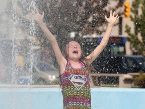 Nine-year-old Rielle cools off in the Memorial Park fountain on the warm afternoon of Sunday May 24, 2015. (Brian Donogh/Winnipeg Sun)