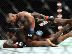 Anthony Johnson (red gloves) and Daniel Cormier (blue gloves) fight during their light heavyweight championship bout during UFC 187 at MGM Grand Garden Arena. Cormier won via third round TKO. (Joe Camporeale-USA TODAY Sports)