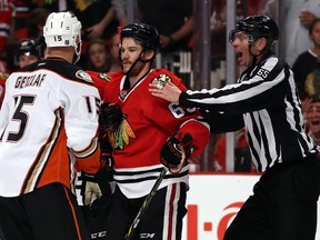 Ryan Getzlaf #15 of the Anaheim Ducks and Andrew Shaw #65 of the Chicago Blackhawks get involved after the whistle in the second period of Game Four of the Western Conference Finals during the 2015 NHL Stanley Cup Playoffs at the United Center on May 23, 2015 in Chicago, Illinois. (Jonathan Daniel/Getty Images/AFP)