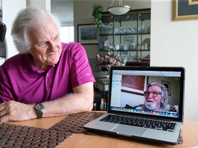 Dave Smith, left, looks over at his brother Mike White, who lives in Scotland, as they talk on Skype at Smith?s home. A 23-year search ended this month when the two met for the first time. (CRAIG GLOVER, The London Free Press)