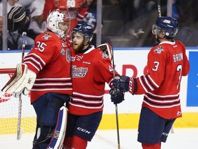 Oshawa Generals' goaltender Ken Appleby (35) is congratulated on their win over the Rimouski Oceanic by team mates Dakota Mermis (44) and Josh Brown (3) in their Memorial Cup hockey game in Quebec City, May 23, 2015  REUTERS/Christinne Muschi