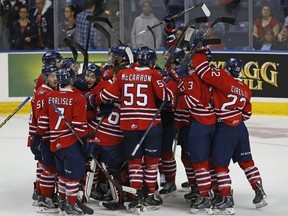 Oshawa Generals players celebrate their overtime victory against the Quebec Remparts during their Memorial Cup hockey game at the Colisee Pepsi in Quebec City, May 24, 2015. REUTERS/Mathieu Belanger