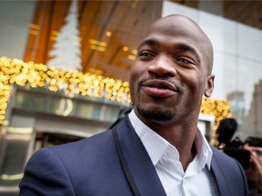 Suspended Minnesota Vikings running back Adrian Peterson exits his hearing against the NFL over his punishment for child abuse, in New York, in this file photo taken December 2, 2014. Peterson, who was suspended by the NFL for using a tree branch to discipline his son, has been reinstated, the league said on Thursday.  (REUTERS/Brendan McDermid/Files)