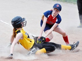 The Mitchell Hornets began their fastball season the last week or so. The Pee Wee girls scored six runs in their final at-bat to battle visiting St. Marys to an 11-11 deadlock, with an early run crossing the plate when Madison Larivee slides beneath the tag of St. Marys’ Kaitlyn Sleeper. ANDY BADER/MITCHELL ADVOCATE