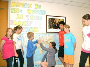 Six of the students involved with the Upper Thames Elementary School (UTES) Peace Tree helped Grade 2 student Waylon Currie find Holland – the country where some of his family come from – on the UTES Heritage World Map in the front hall at the school. Pictured from left: Emma Hooper, Brianna Cook, Currie, Lily Bell-Dunlop, Eason Wu, Tanner Dietz and Maddie LaBlanc. GALEN SIMMONS/MITCHELL ADVOCATE