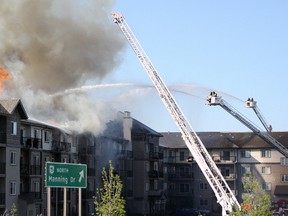 Firefighters fight a fire at a condo in Edmonton, May 22, 2015. (CLAIRE THEOBALD/Postmedia Network)