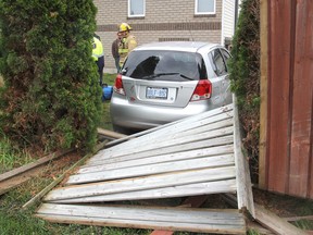 A car veered off Bayridge Drive in Kingston, Ont. and crashed through a fence near Roosevelt Drive, slamming up against the home's deck on Mon., May 25, 2015 after it suddenly left the road, possibly due to a medical condition. The driver was taken to hospital by ambulance. Michael Lea/The Whig-Standard/PostMedia Network