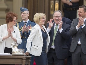 Alberta New Democratic Party (NDP) Leader Rachel Notley (C) is sworn in as Alberta's 17th premier at her official swearing-in ceremony in Edmonton, Alberta, May 24, 2015. REUTERS/Topher Seguin