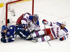 Tampa Bay Lightning left winger Ondrej Palat collides with New York Rangers goalie Henrik Lundqvist and defenceman Keith Yandle collide during Game 4 of the Eastern Conference on March 22, 2015. (Reinhold Matay/USA TODAY Sports)
