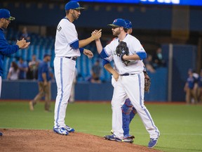Toronto Blue Jays starting pitcher Drew Hutchison celebrates with left fielder Chris Colabello (after defeating the Chicago White Sox 6-0 at Rogers Centre on May 25, 2015. (Nick Turchiaro/USA TODAY Sports)