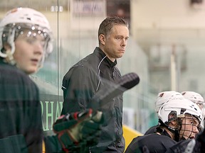 Former Belleville Bulls player and assistant coach Jake Grimes is shown behind the bench during a training camp scrimmage at Yardmen Arena.