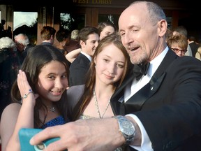 Actor Colm Feore obliges for a photo with sisters and theatre fans Megan, left, and Julia St. Pierre, 12 and 16 respectively, at the opening of the Stratford Festival’s 2015 season on Monday in Stratford. (Scott Wishart/Postmedia Network)