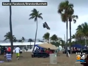 A waterspout touched down on Florida's Fort Lauderdale beach Monday, lifting an inflatable bouncy house into the air and injuring three children.
(Screenshot from YouTube)