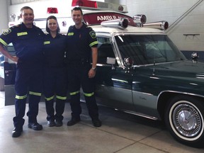 Elgin-St. Thomas paramedics Joe Hill, left, Sareen Tucker and Aaron Smith in front of a 1971 Cadillac ambulance at the Medavie EMS Elgin St. Thomas open house Monday. Visitors were able to take a look at modern paramedic equipment as well as two historic vehicles.