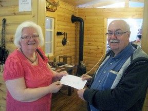 Dawn Monroe, publisher of the Heritage Village Herald, presents the Cochrane Polar Bear Habitat's Paul Latendresse with a cheque of $400 to be used exclusively for Heritage Village which is located at the Habitat.