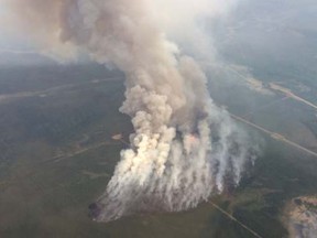 Smoke rises from a wildfire east of Slave Lake, Alberta May 25, 2015 in a photo supplied by the Alberta Wildfire Info department.  REUTERS/Alberta Environment and Sustainable Resource Development (ESRD)/handout via Reuters