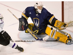 Windsor Lancers goalie Parker Van Buskirk stops a tipped shot by Western Mustang Adam Nemeth in this 2012 file photo. Nemeth has joined the St. Thomas Stars' coaching staff for the coming season.