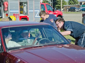 The Pincher Creek EMS put on a car extraction demo and barbecue for spectators last week. The "victims" were played by St. Mike's Grade 12 students and the cars were provided by M&M Motors. John Stoesser photos/Pincher Creek Echo.