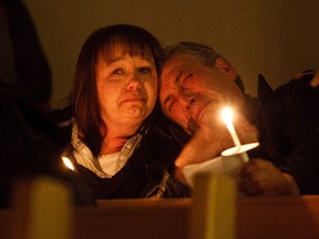 Tony Kwiatkowski (right) is comforted by friend Raylene each as they remember Tony's son, John at St. Michael's and All Angels Anglican Church in Edmonton, Alta. on Monday, Dec. 10, 2012.. Family and friends gathered to take part in a candlelight service to remember victims of homicide. John Stanley Kwiatkowski was murdered on April 14, 2011 in Edmonton, Alta. Codie McLachlan/Edmonton Sun