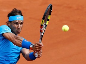 Rafael Nadal plays a shot to Quentin Halys during their match at the French Open at the Roland Garros stadium in Paris May 26, 2015. (REUTERS/Pascal Rossignol)