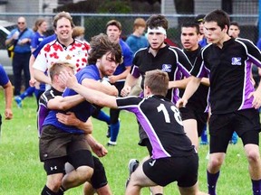 Sarnia Collegiate Blue Bombers inside centre Alex Gratton fights through a tackle during a Lambton Kent senior boys high school rugby semifinal against the St. Clair Colts Thursday, May 21 in Sarnia, Ont. (Handout Photo/Sarnia Observer/Postmedia Network)