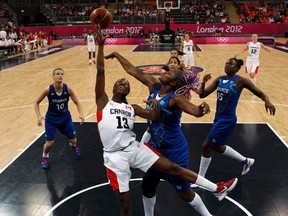 Canada's Tamara Tatham tangles with France players in this shot from the 2012 Olympics in London. Canada will face France and a number of other European national teams on its current exhibition tour. (Reuters)