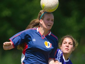 Maddy Curtis, of Oakridge, heads the ball in front of Andie Sheidow, of Central, during the Thames Valley Central AAA girls? soccer championship game at North London fields Tuesday.  (MIKE HENSEN, The London Free Press)