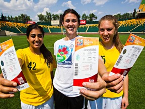 University of Alberta Junior Pandas soccer players Henny Sunner, left, Morgan Corbett, centre, and Salma Kamel hold up their tickets for the FIFA Women’s World Cup Canada 2015 at Commonwealth Stadium on Tuesday. (Codie McLachlan, Edmonton Sun)