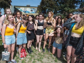 Alexi Halket (centre, yellow shorts, black top) and classmates in front of Etobicoke School of the Arts in Toronto Tuesday May 26, 2015. Halket's crop top ran afoul of the school's dress code. (Ernest Doroszuk/Toronto Sun)