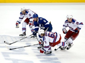 Anton Stralman of the Tampa Bay Lightning skates with the puck against some New York Rangers during the second period in Game 6 of the Eastern Conference finals during the 2015 NHL playoffs at Amalie Arena on May 26, 2015. (Brian Blanco/Getty Images/AFP)