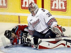 Kelowna Rockets Tyson Baillie collides with Oshawa Generals goalie Ken Appleby during the third period of their Memorial Cup hockey game at the Colisee Pepsi on May 26, 2015. (REUTERS/Mathieu Belanger)