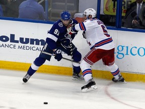 Tampa Bay Lightning centre Steven Stamkos and New York Rangers defenceman Dan Girardi battle for the puck during the second period in Game 6 of the Eastern Conference final of the 2015 NHL playoffs at Amalie Arena on May 26, 2015. 9Reinhold Matay/USA TODAY Sports)