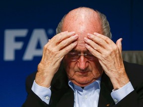 FIFA President Sepp Blatter gestures as he attends a news conference after a meeting of the FIFA executive committee in Zurich in this September 26, 2014 file picture. (Reuters/Arnd Wiegmann/Files)