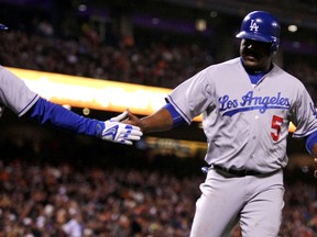 Los Angeles Dodgers third baseman Juan Uribe  (5) scores in the fifth inning of their MLB baseball game with the  San Francisco Giants at AT&T Park. (Lance Iversen-USA TODAY Sports)