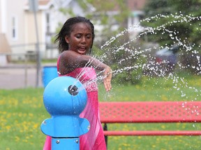 Serene N'Guessan, 10, cools off at the O'Connor Water Park in Sudbury, Ont. on Tuesday May 26, 2015. John Lappa/Sudbury Star/Postmedia Network
