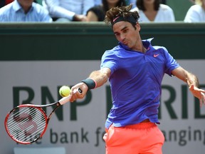 Roger Federer returns the ball to Marcel Granollers during French Open second-round play at Roland Garros stadium in Paris on May 27, 2015. (AFP PHOTO/PASCAL GUYOT)