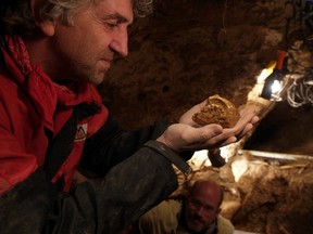 Professor Juan Luis Arsuaga examines an artifact at the Sima de los Huesos site in Sierra de Atapuerca, Spain. (REUTERS/Copyright Javier Trueba)