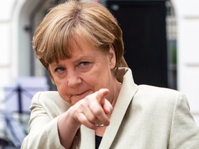 German Chancellor Angela Merkel gestures during her visit to the Roentgen school in Berlin, Germany, May 12, 2015.  (MAURIZIO GAMBARINI/Reuters/Pool)