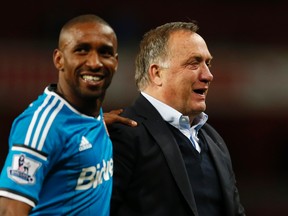 Sunderland manager Dick Advocaat celebrates with Jermain Defoe at the end of their game against Arsenal at Emirates Stadium after avoiding relegation. (Reuters/John Sibley)