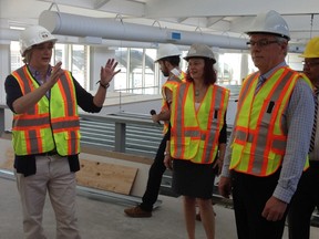 Premier Greg Selinger (right), Health Minister Sharon Blady (centre) and Cheryl Susinksi of the Rehabilitation Centre for Children tour the Notre Dame facility that will house the province's Specialized Services for Children and Youth on May 27, 2015.