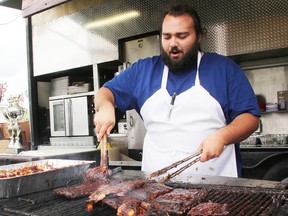 Kentucky Smokehouse's Victor Anast works the grill at last year's Sarnia Ribfest. This year's event is set for Father's Day weekend, June 19, 20 and 21, at Hiawatha Horse Park. (File photo/Sarnia Observer/Postmedia Network)