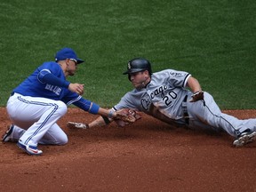 White Sox baserunner J.B. Shuck avoids the tag of Blue Jays second baseman Ryan Goins while stealing second during second inning MLB action in Toronto on Wednesday, May 27, 2015. (Tom Szczerbowski/Getty Images/AFP)