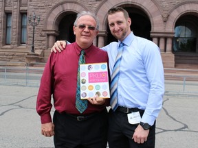 John Adams, president and CEO of CanPKU, and his son John who lives with the genetic disease outside Queen's Park on May 27 2015. (Toronto Sun/Antonella Artuso)