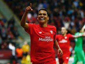 Carlos Bacca celebrates scoring the third goal for Sevilla.