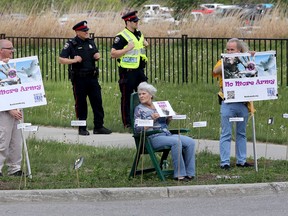 Approximately 50 peace activists staged a 10-hour protest in front of the EY Centre in Ottawa Ont. Wednesday May 27, 2015. The peace activists wanted to get the attention of people arriving and leaving the Cansec weapons show Wednesday. Tony Caldwell/Ottawa Sun/Postmedia Network