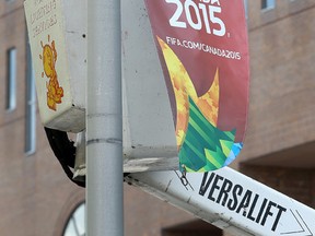 A worker puts up a FIFA Women's World Cup 2015 banner on Elgin Street in Ottawa Ont. Thursday May 21, 2015. Tony Caldwell/Ottawa Sun/Postmedia Network