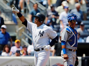 Kansas City Royals catcher Salvador Perez (13) watches New York Yankees designated hitter Alex Rodriguez (13) celebrate after he hit a three-run homer Wednesday at Yankee Stadium. (Noah K. Murray/USA TODAY Sports)