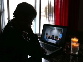Nana watches Bridget Takyi giving her statement to police from her Calgary home. (Darren Makowichuk/Calgary Sun/Postmedia Network)