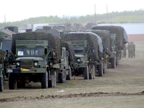 A Canadian soldier lines up support vehicles before they move out of the staging area of 3rd Canadian Division Support Group in the Wainwright training area.
Sgt Dan Shouinard/DND Combat Camera